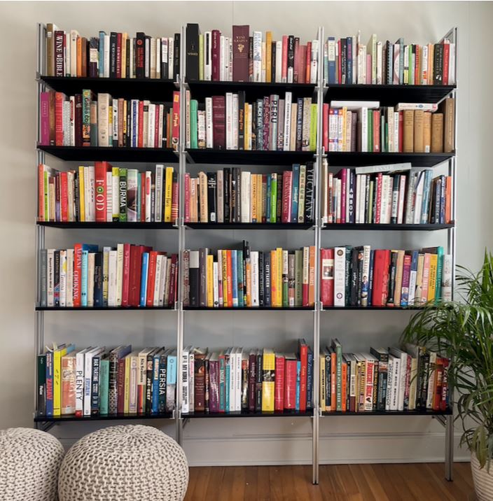 Modular shelving extension with black shelves and black vertical post, shown with open shelf levels.