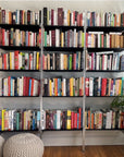 Modular shelving extension with black shelves and black vertical post, shown with open shelf levels.