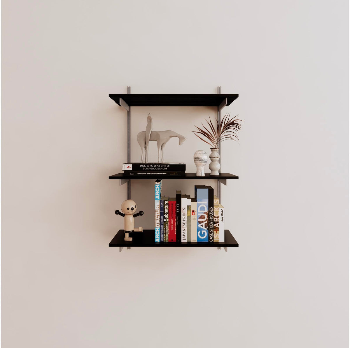 Modular shelving unit with black shelves, satin vertical posts, and one bay, shown with three open shelf levels.
