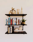 Modular shelving unit with one bay, shown with three open shelf levels styled in a room setting.