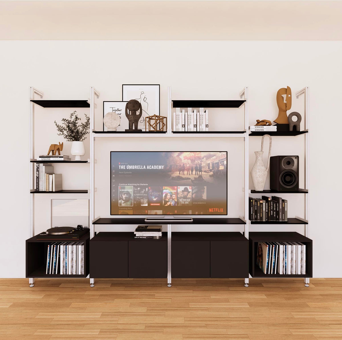 Harmony four-bay media unit with black shelves and white vertical posts, four bays, shown with open shelf levels.