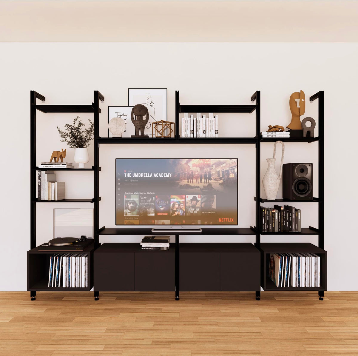 Harmony four-bay media unit with black shelves and black vertical posts, four bays, shown with open shelf levels.