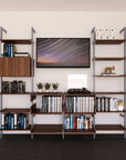 Four-bay media center shelving unit with wood-look shelves and satin vertical posts, four bays, shown with open shelf levels.