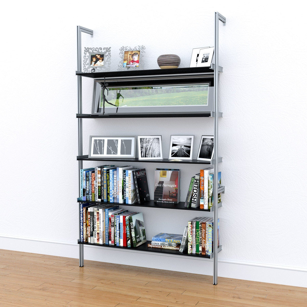 Modular shelving unit with black shelves and satin vertical posts, styled in a room setting with books, plants, and decor.